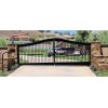 Ranch Valley driveway gate ideas swing gate with keypad. Gate is affixed to two stone pillars. White pickup truck and white sedan on the opposite side. 