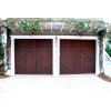 Two dark stained garage doors with white edging on a beautiful home in Lakeside, California
