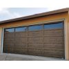 Garage door with 25 rectangular panels on it. Four panels across the top are glass.