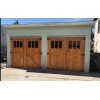 Historic looking, wood stained, carriage doors on a brick San Diego garage.