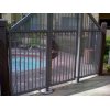 Single swing gate attached to a fence surrounding a swimming pool in El Cajon, CA.