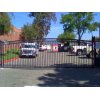 Wrought iron swing gate with vertical spindles and arched top in San Diego
