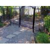 Wrought iron pool fence with a rounded swinging pedestrian gate.
