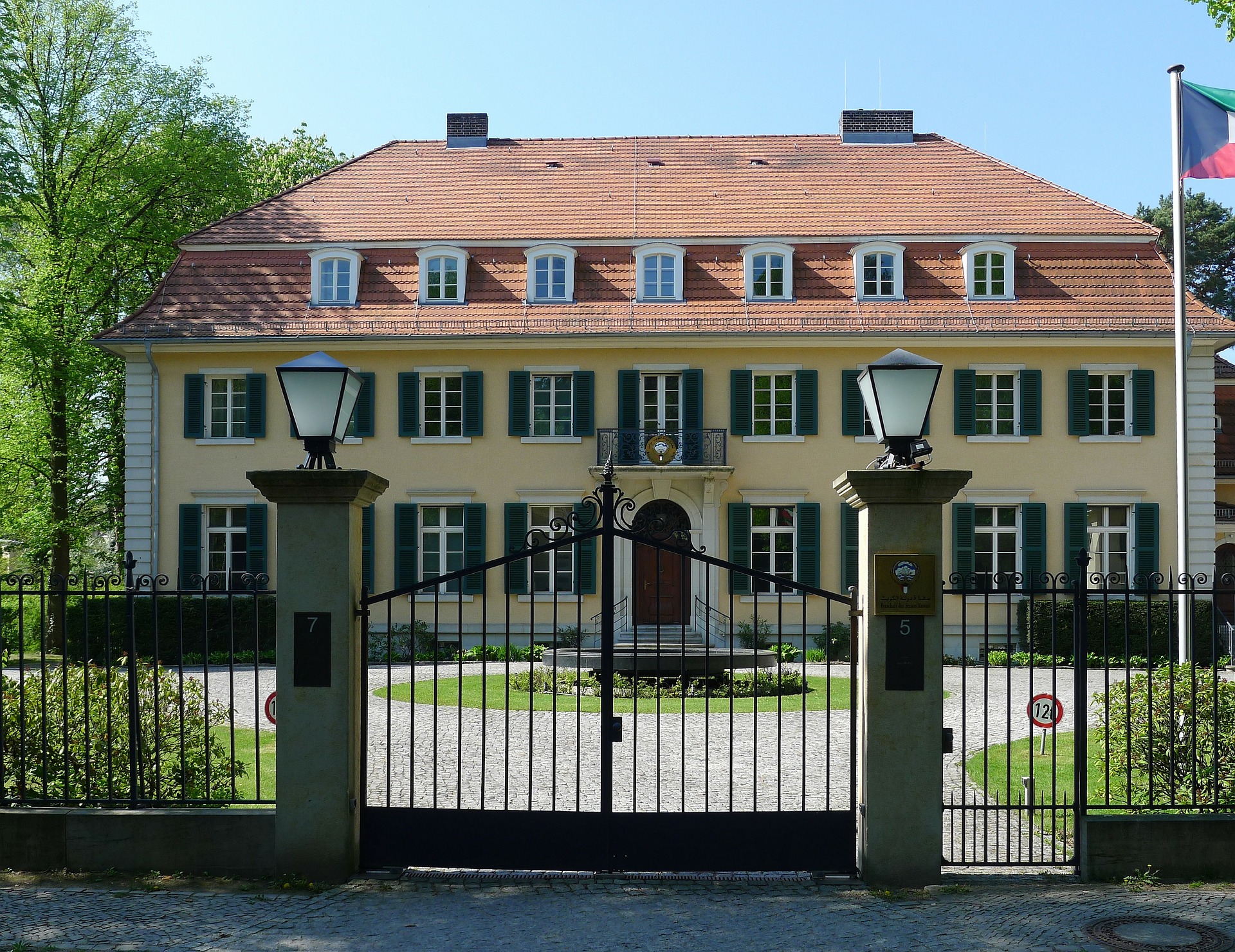 beautiful home with wrought iron fence in foreground