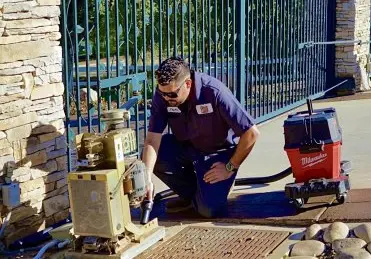 Technician repairing a garage door spring